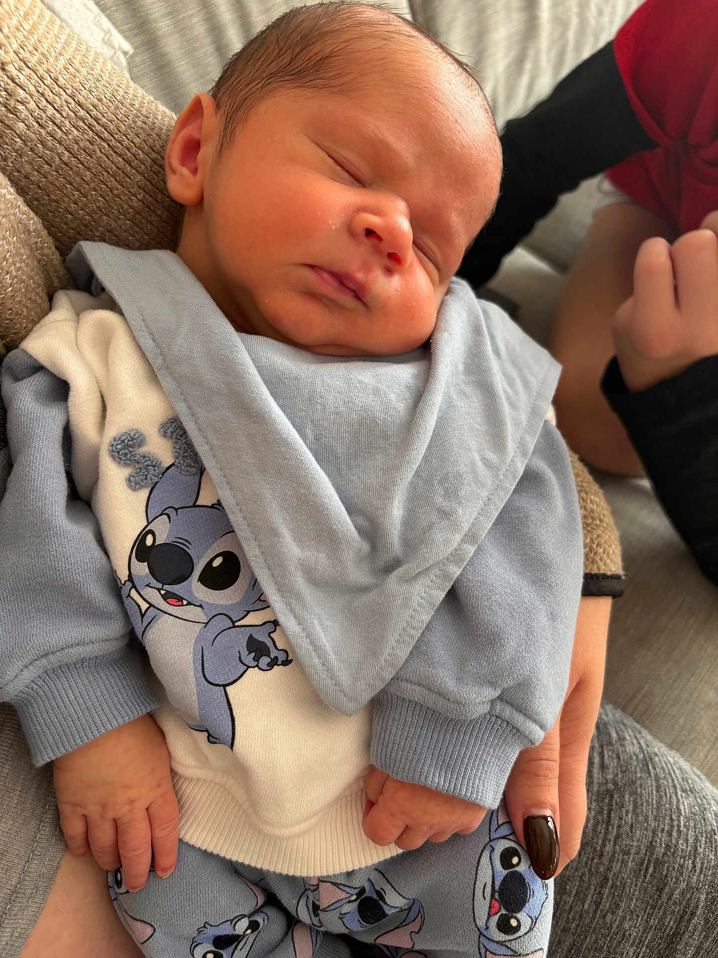 Cameron participe au concours pour gagner de l'argent avec cette photo : baby, newborn, sleeping, infant, person, clothing, blue, white, stitch_character, cartoon, hand, holding, cozy, fabric, sleeve, pajamas, cute, portrait, indoor, resting