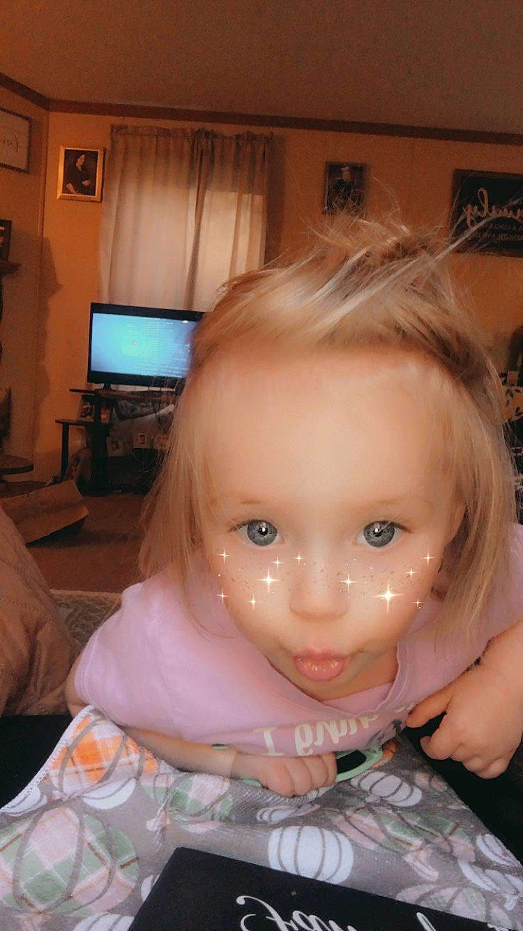 Joelle is registered to the contest to win money with this photo: bangs, brown_hair, cheek, child, chin, curtain, ear, eye, eyebrow, eyelash, fun, iris, jaw, lip, mouth, nose, person, sitting, skin, smile