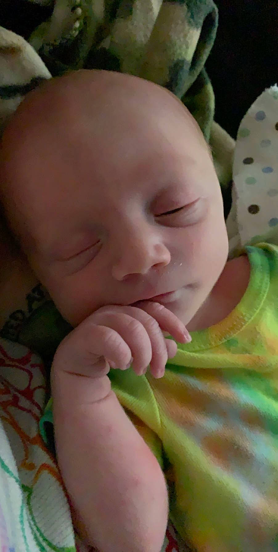 Micheal is registered to the contest to win money with this photo: baby, cheek, child, eye, face, finger, hand, head, lip, mouth, nose, person, skin, sleep, toddler