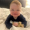 Cade joined the competition — help win amazing prizes! baby, smiling, bed, blanket, stuffed_animal, red_hair, indoors, lamp, headboard, face, child, cozy, soft_light, toy, crawling, happy, cute, infant, person, portrait