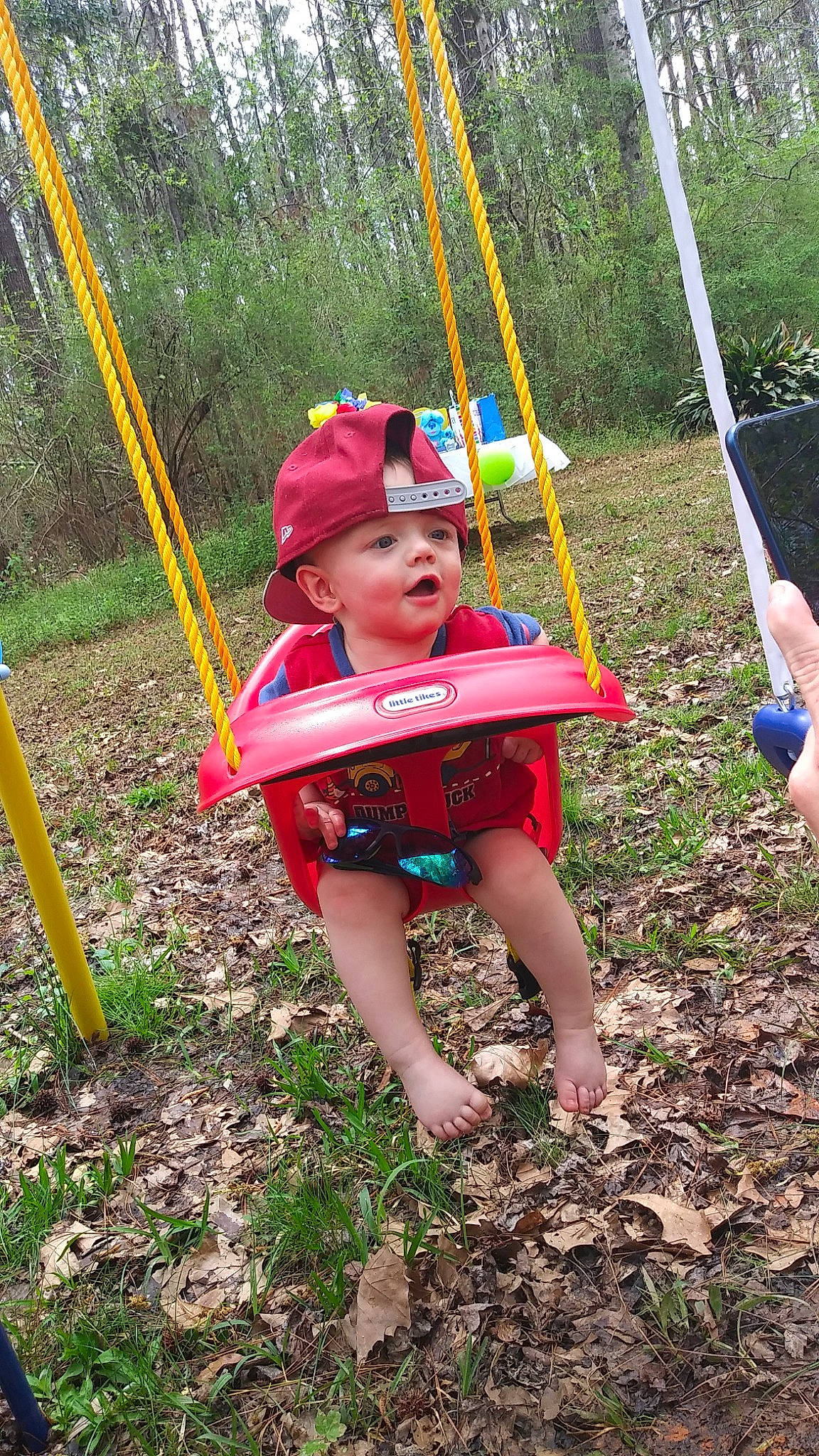 Kodi joined the competition — help win amazing prizes! baby, child, city, fun, gardening, grass, headwear, leisure, outdoor_play_equipment, people_in_nature, person, plant, play, playground, recreation, shade, shorts, soil, swing, t_shirt