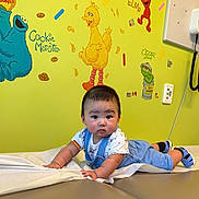 Maisson joined the competition — help win amazing prizes! baby, big_bird, blue_overalls, child, cookie_monster, curious, cute, elmo, hospital_room, indoor, infant, medical_equipment, medical_exam_table, oscar_the_grouch, sesame_street, shoes, socks, wall_art, white_tshirt, yellow_wall