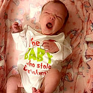 Rowyn is registered to the contest to win money with this photo: baby, newborn, yawning, blanket, pink, unicorn, onesie, clothing, infant, cute, sleepy, soft, cozy, lying_down, indoors, face, hand, foot, christmas, holiday