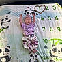 Rowyn is registered to the contest to win money with this photo: baby, infant, panda, blanket, milestone, numbers, purple_clothing, headband, floral_pants, raising_arms, cute, lying_down, indoor, decor, pattern, child, newborn, soft, playful, smiling_panda