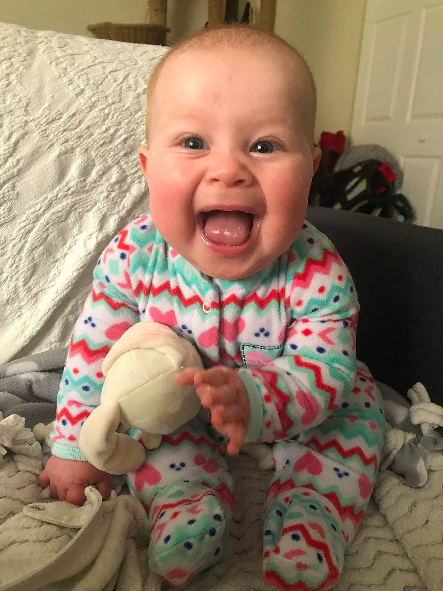 Alyssa is registered to the contest to win money with this photo: baby, baby_toddler_clothing, cheek, child, comfort, facial_expression, finger, flooring, fun, happy, head, mouth, nose, people, person, product, sitting, skin, sleeve, smile