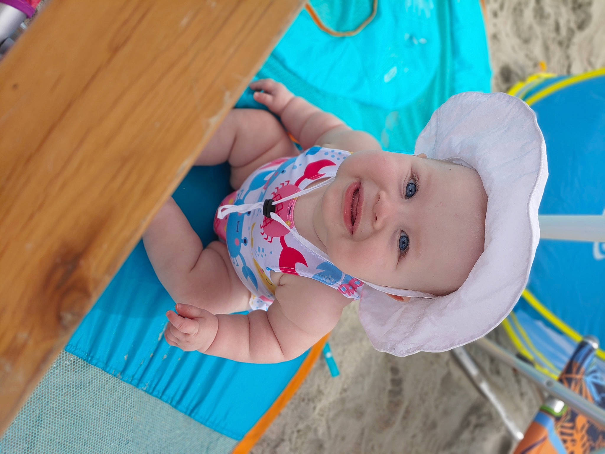 Alyssa is registered to the contest to win money with this photo: azure, baby, baby_toddler_clothing, child, electric_blue, fun, happy, hardwood, hat, headwear, joy, leisure, pattern, person, plank, play, recreation, skin, smile, toddler
