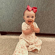 Ashtynn joined the competition — help win amazing prizes! baby, child, infant, smiling, happy, clapping, bow, headband, carpet, floor, sitting, cute, clothing, indoor, person, face, expression, young, toddler, background
