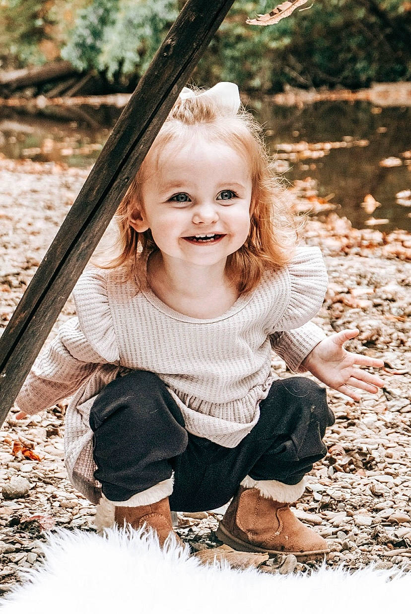 Georgia is registered to the contest to win money with this photo: branch, facial_expression, flash_photography, fun, grass, hairstyle, happy, joy, leisure, mammal, nature, people_in_nature, person, plant, smile, standing, style, sunlight, toddler, tree
