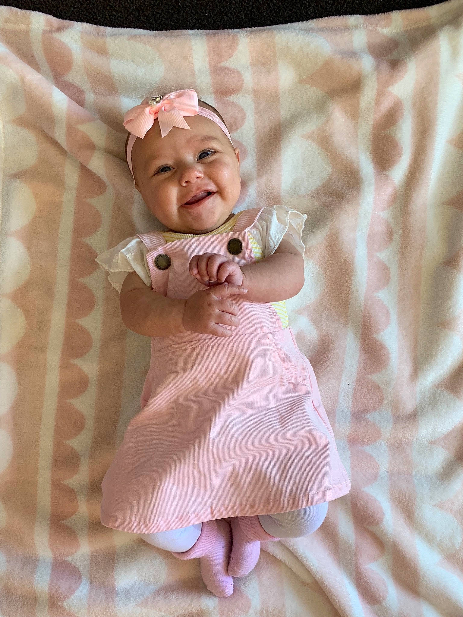 Amyah is registered to the contest to win money with this photo: baby, child, dress, linens, person, pink, smile, textile, toddler, toy