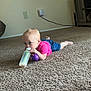 toddler, baby, carpet, floor, bottle, toy, purple, pink_shirt, blue_shorts, indoor, child, person, crawling, curious, home, cabinet, wall, power_outlet, foot, head