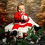 Manolo participe au concours pour gagner de l'argent avec cette photo : baby, child, santa_suit, christmas, holiday, festive, ornaments, pine_cones, greenery, fluffy_cushion, smiling, winter, snowy_background, indoor, portrait, cute, seasonal, decorations, holiday_cheer, happy