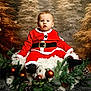 Manolo participe au concours pour gagner de l'argent avec cette photo : baby, child, santa_suit, christmas, holiday, festive, decorations, pinecones, greenery, cushion, fur, portrait, indoor, seasonal, cute, smiling, festive_clothing, background, christmas_tree, winter