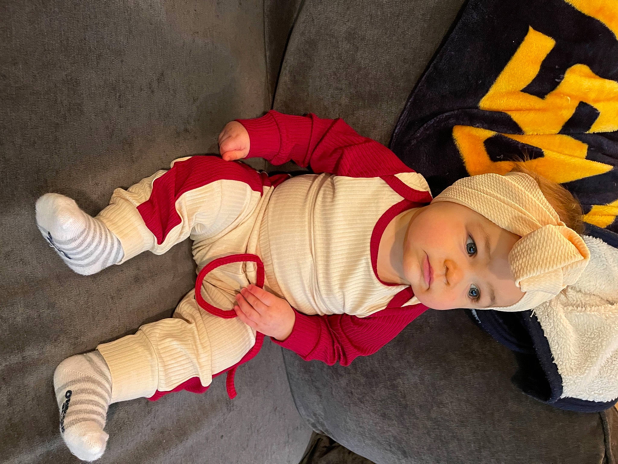 Ada is registered to the contest to win money with this photo: baby, baby_products, baby_toddler_clothing, beanie, bonnet, carmine, cheek, child, comfort, costume, costume_accessory, headgear, headwear, lap, person, sock, toddler, walking_shoe