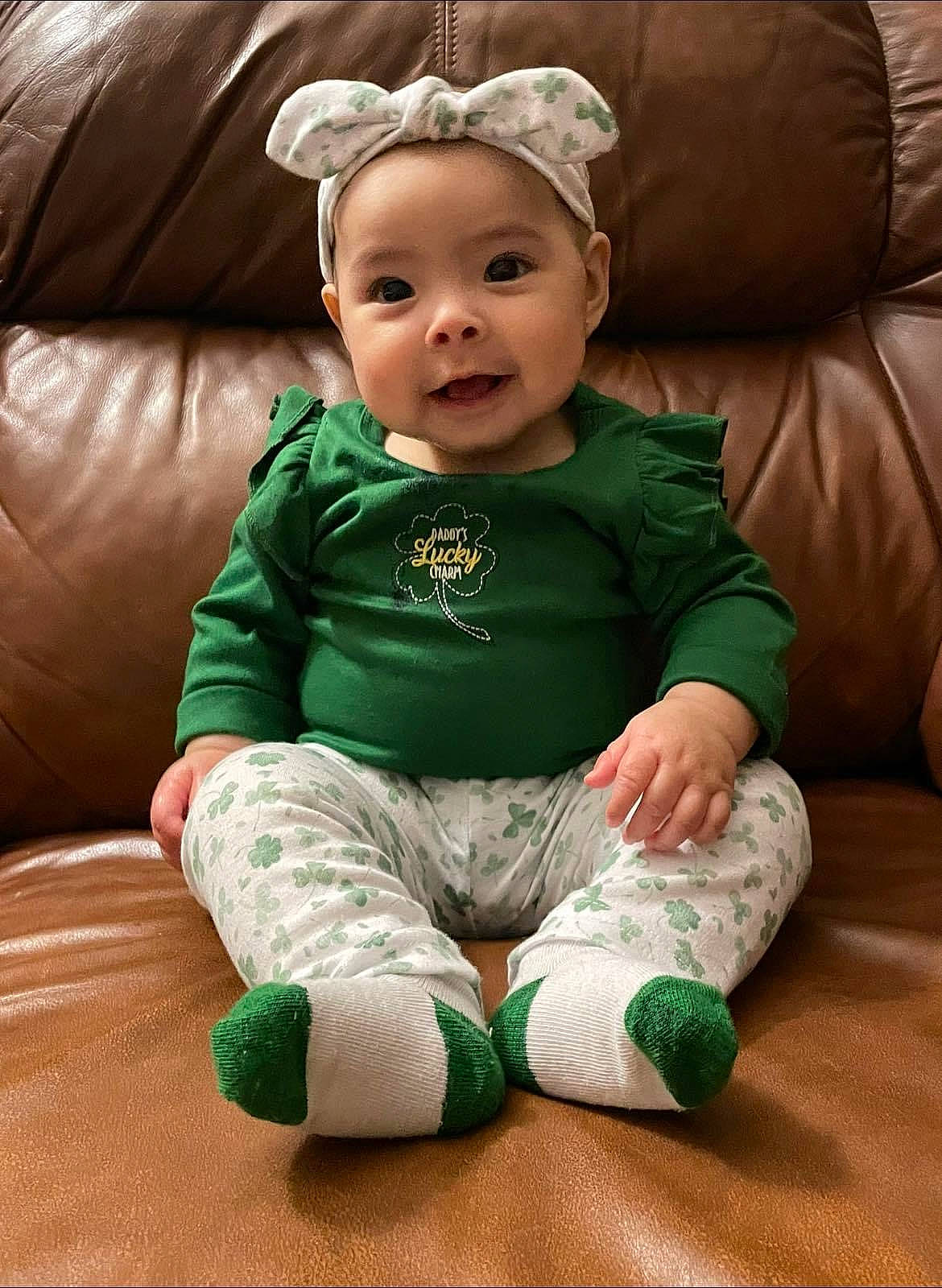 Ellianna is registered to the contest to win money with this photo: baby, baby_toddler_clothing, cheek, child, comfort, couch, eye, face, facial_expression, finger, grass, happy, head, headwear, outerwear, person, sitting, skin, sleeve, smile