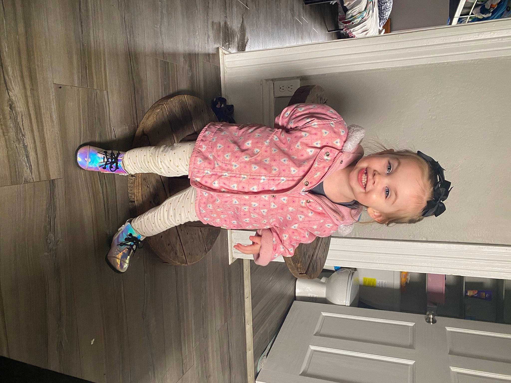 Esmae is registered to the contest to win money with this photo: baby_toddler_clothing, child, comfort, elbow, floor, flooring, fun, hardwood, human_leg, joy, knee, leg, magenta, person, pink, room, smile, sock, thigh, toddler