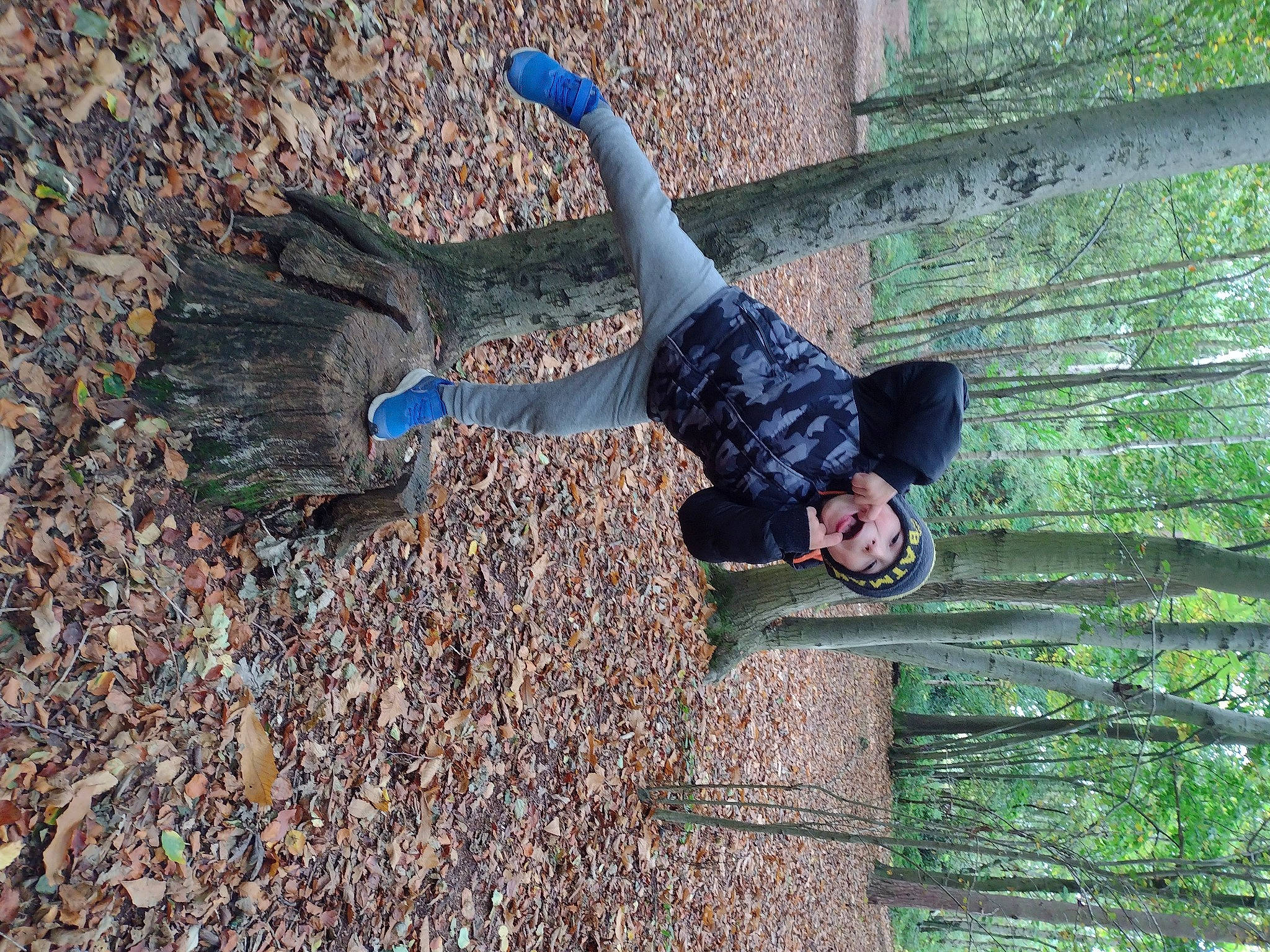 Jakub is registered to the contest to win money with this photo: active_pants, adventure, forest, fun, grass, headwear, leaf, leisure, people_in_nature, person, plant, recreation, rock, smile, soil, street_fashion, tree, trunk, wood, woody_plant