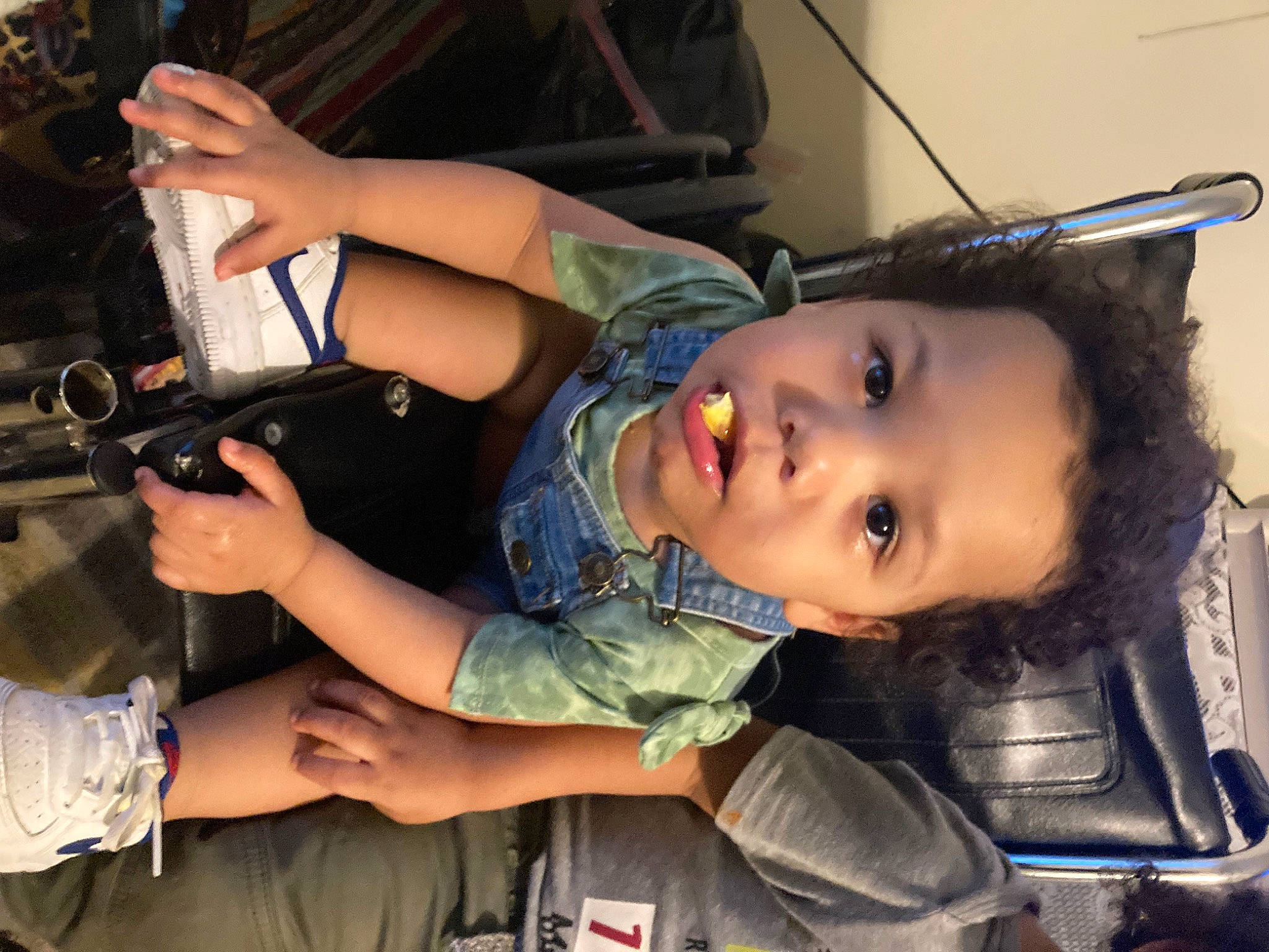 Levin is registered to the contest to win money with this photo: auto_part, baby_products, bag, chair, child, fun, hairstyle, human_leg, luggage_and_bags, person, sitting, skin, thigh, toddler