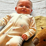 Mariella joined the competition — help win amazing prizes! adorable, baby, bedroom, blanket, cheeks, closeup, cozy, cute, fabric, hair, hand, infant, lying_down, newborn, onesie, portrait, relaxed, smile, soft_toy, stuffed_animal