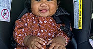Amerie joined the competition — help win amazing prizes! baby, black_hair, car_seat, child, closeup, clothing, cute, dress, hand, happy, indoors, infant, pattern, person, portrait, seat_belt, sitting, skin, smiling, young