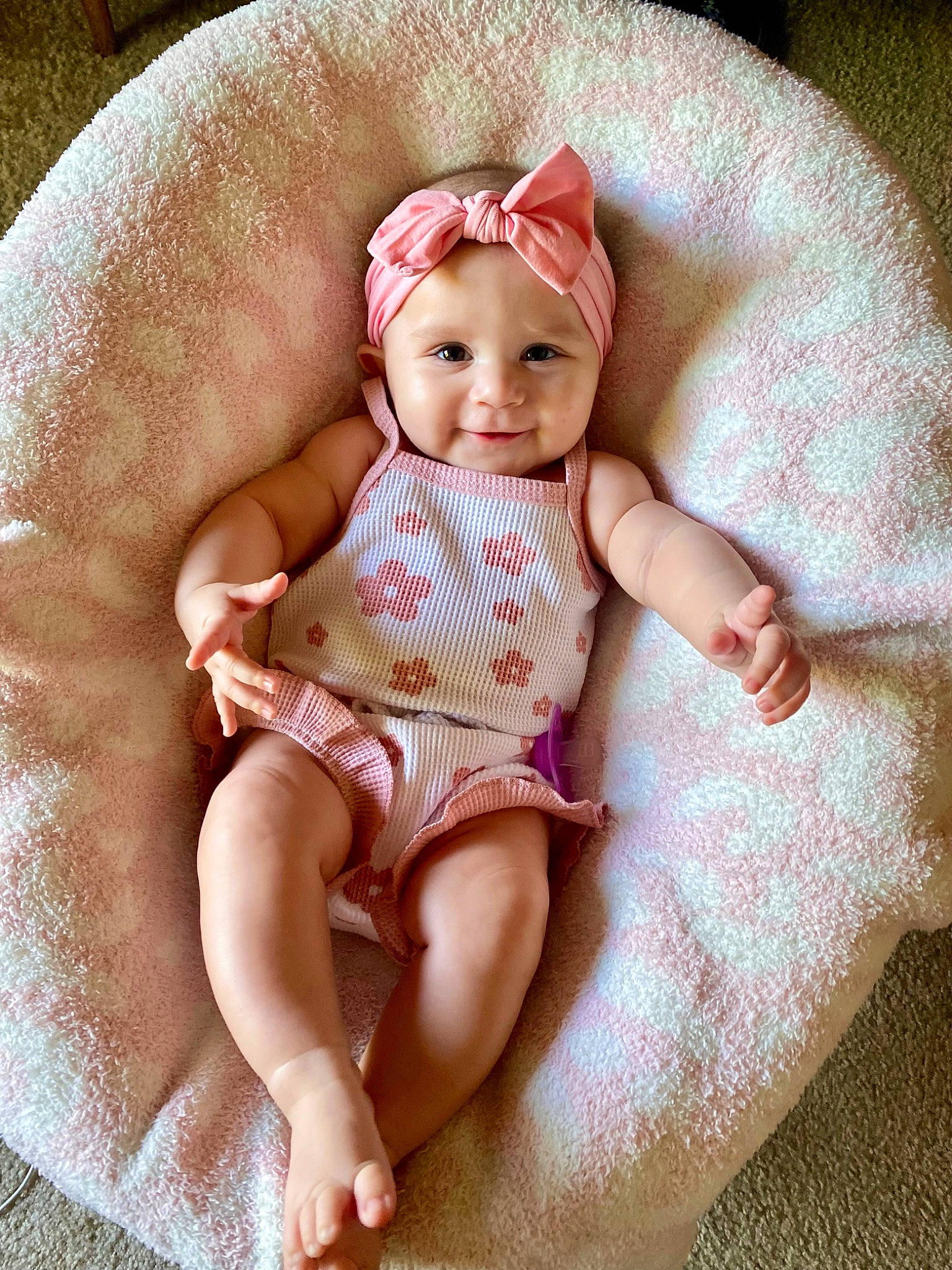 Leila joined the competition — help win amazing prizes! arm, baby, baby_toddler_clothing, comfort, eye, face, fashion_accessory, foot, headwear, human_body, human_leg, knee, lap, linens, pattern, person, pink, sleeve, smile, sun_hat
