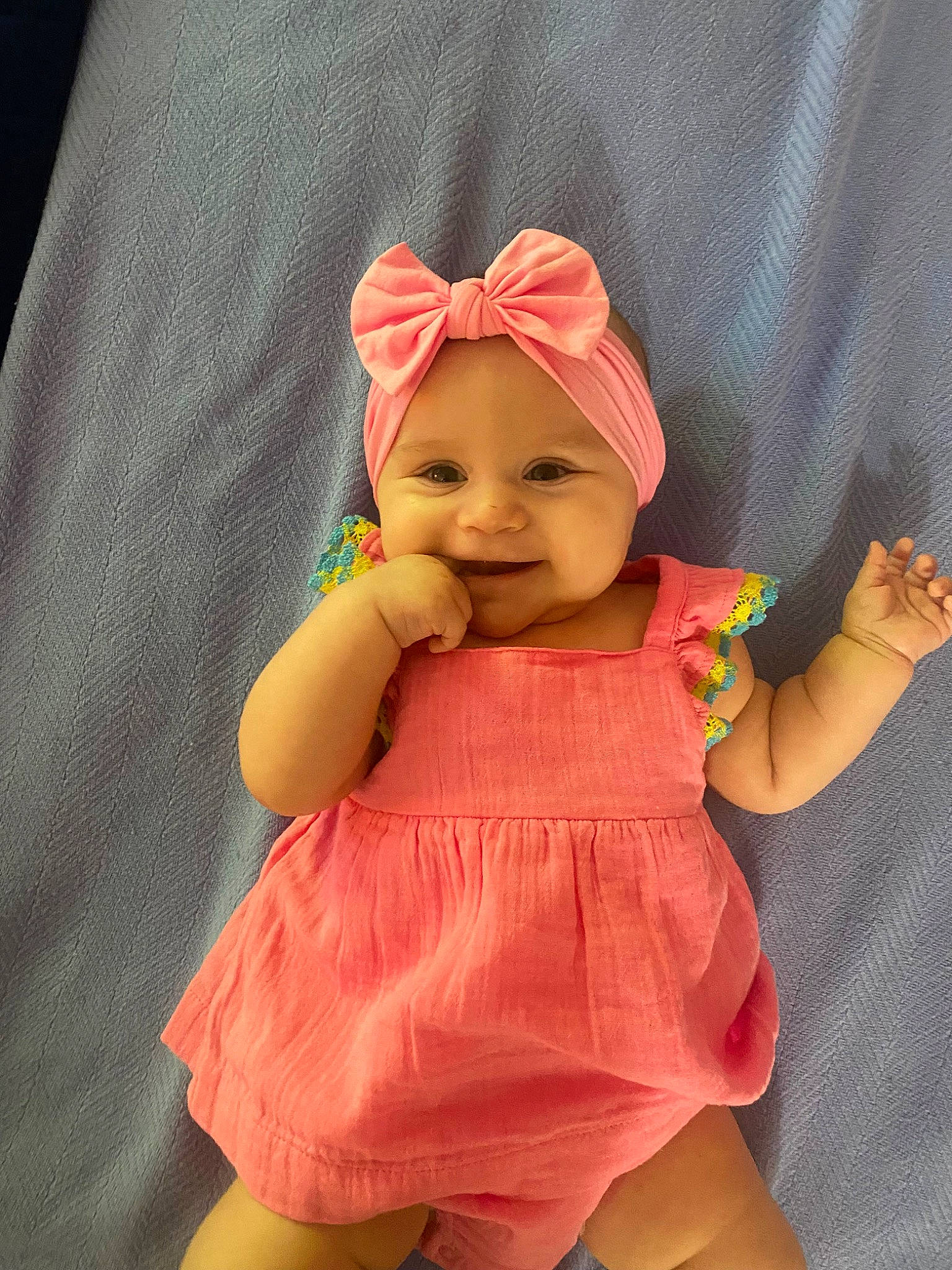 Leila joined the competition — help win amazing prizes! baby, baby_products, baby_toddler_clothing, cap, child, doll, fashion_accessory, fun, happy, headgear, headwear, human_leg, magenta, peach, person, pink, sitting, skin, sleeve, smile