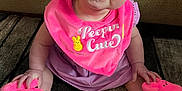 Alyssa joined the competition — help win amazing prizes! baby, blue_eyes, carpet, child, clothing, cute, face, footwear, happy, indoors, infant, person, pink_bib, pink_hat, pink_slippers, plush, portrait, purple_dress, sitting, smiling