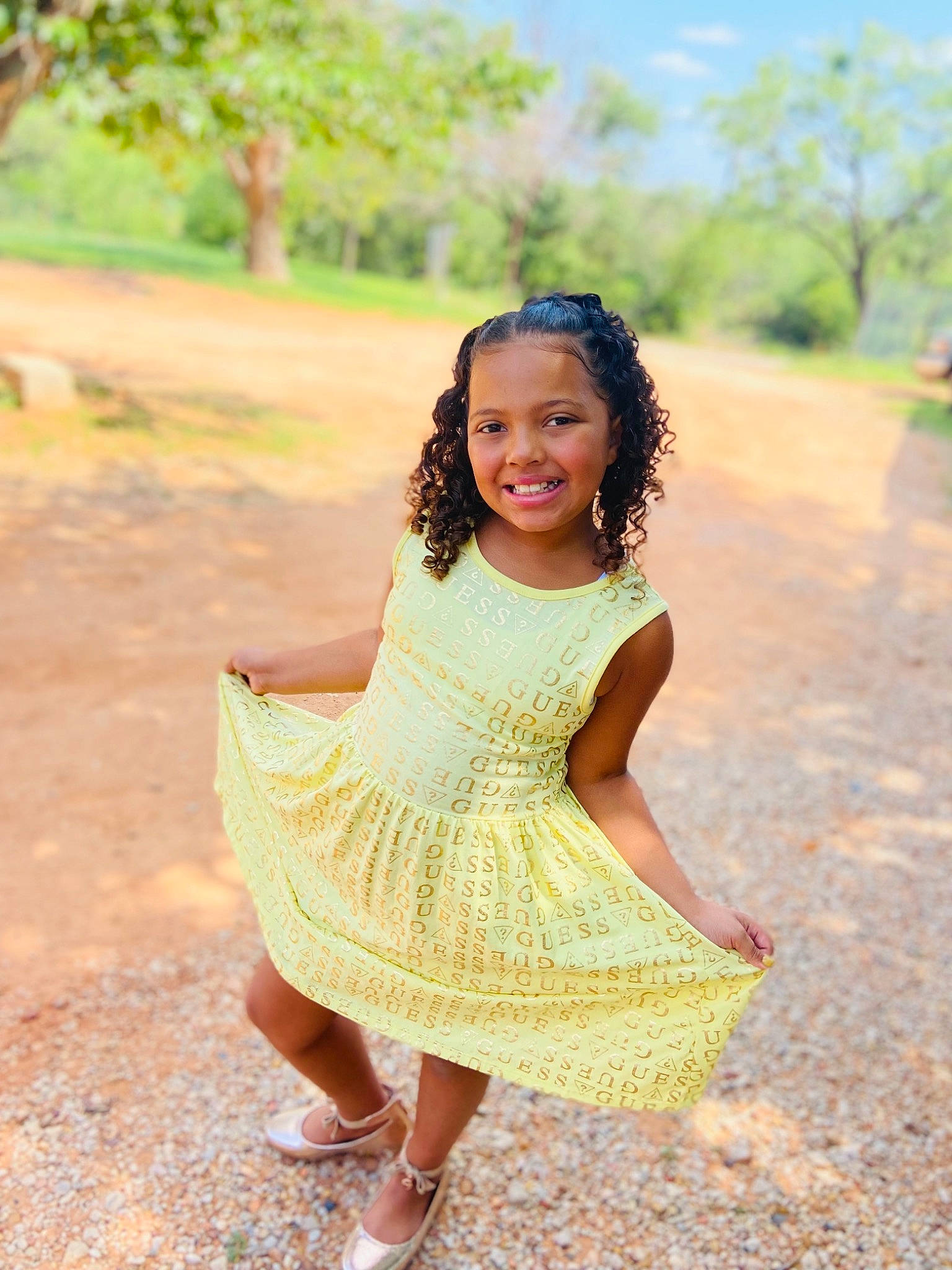 Anyah is registered to the contest to win money with this photo: beauty, dress, fawn, fun, grass, happy, joy, leaf, leisure, mammal, people_in_nature, person, plant, sandal, smile, summer, sunlight, toddler, tree, trunk