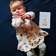 Jade participe au concours pour gagner de l'argent avec cette photo : baby, infant, polka_dot, dress, leggings, bunny, card, illustration, hand, lying_down, cute, child, indoors, cloth, fabric, person, soft, girl, feet, playful