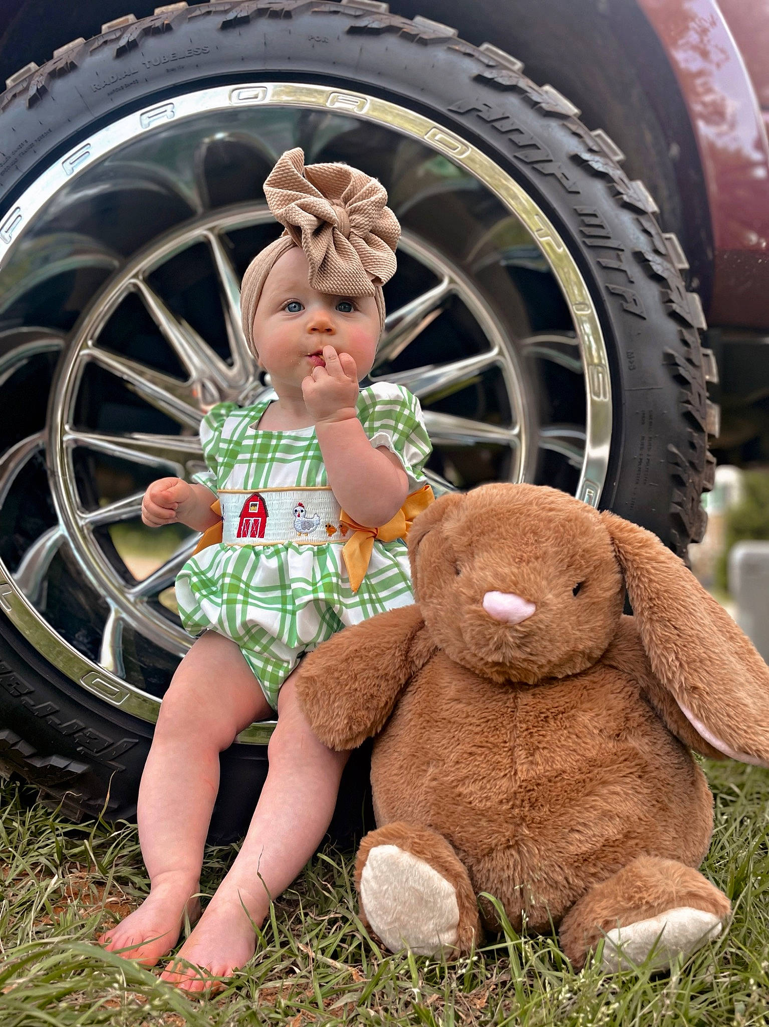 Dallas is registered to the contest to win money with this photo: alloy_wheel, automotive_design, automotive_lighting, automotive_tire, car, eye, grass, head, hubcap, human_body, mammal, motor_vehicle, person, plant, synthetic_rubber, tire, toy, tread, vehicle, vertebrate