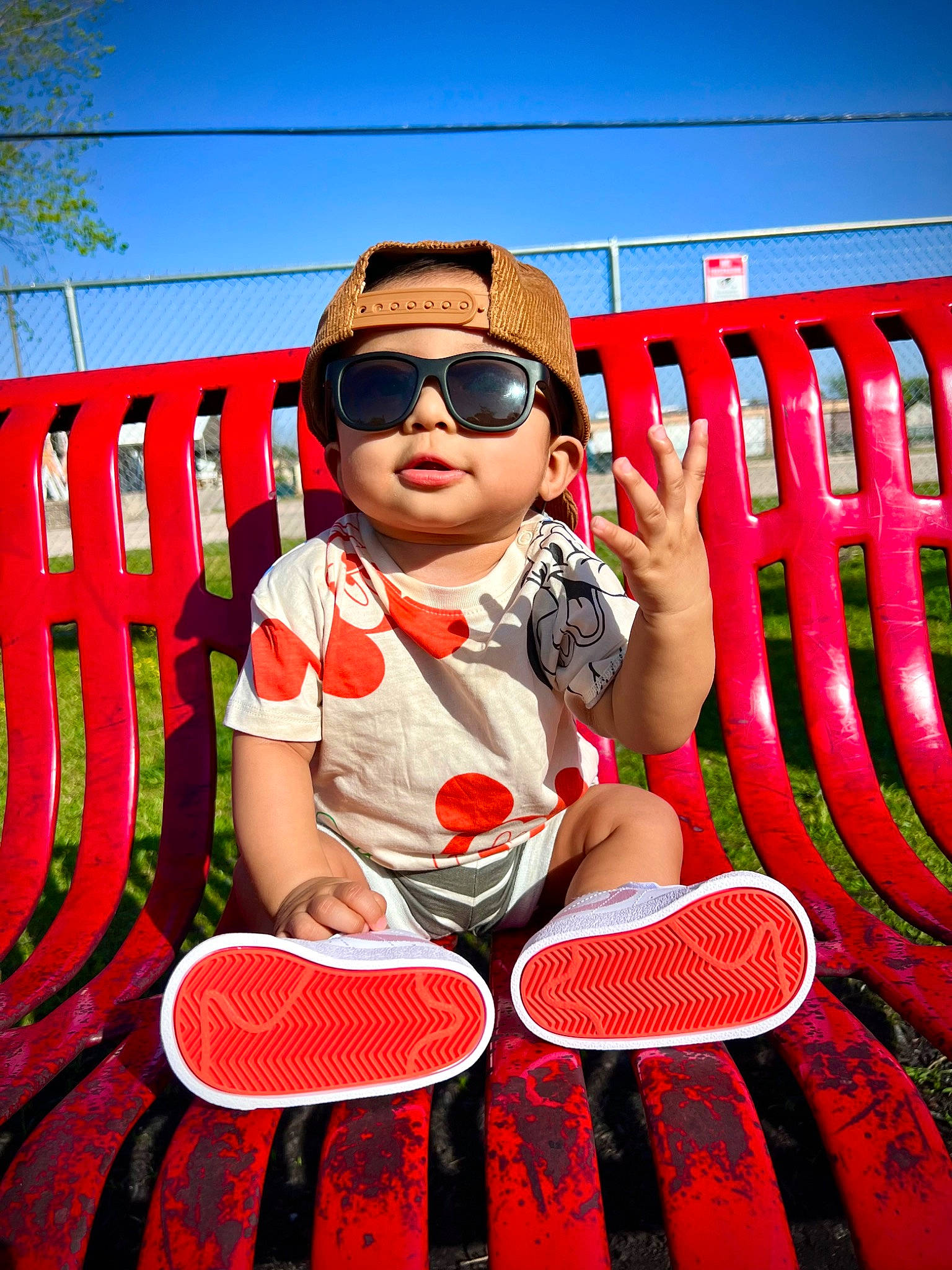 Keanu is registered to the contest to win money with this photo: baby_toddler_clothing, cap, cool, event, eyewear, fun, glasses, goggles, grass, happy, hat, leisure, person, product, red, sky, sunglasses, thigh, toddler, travel