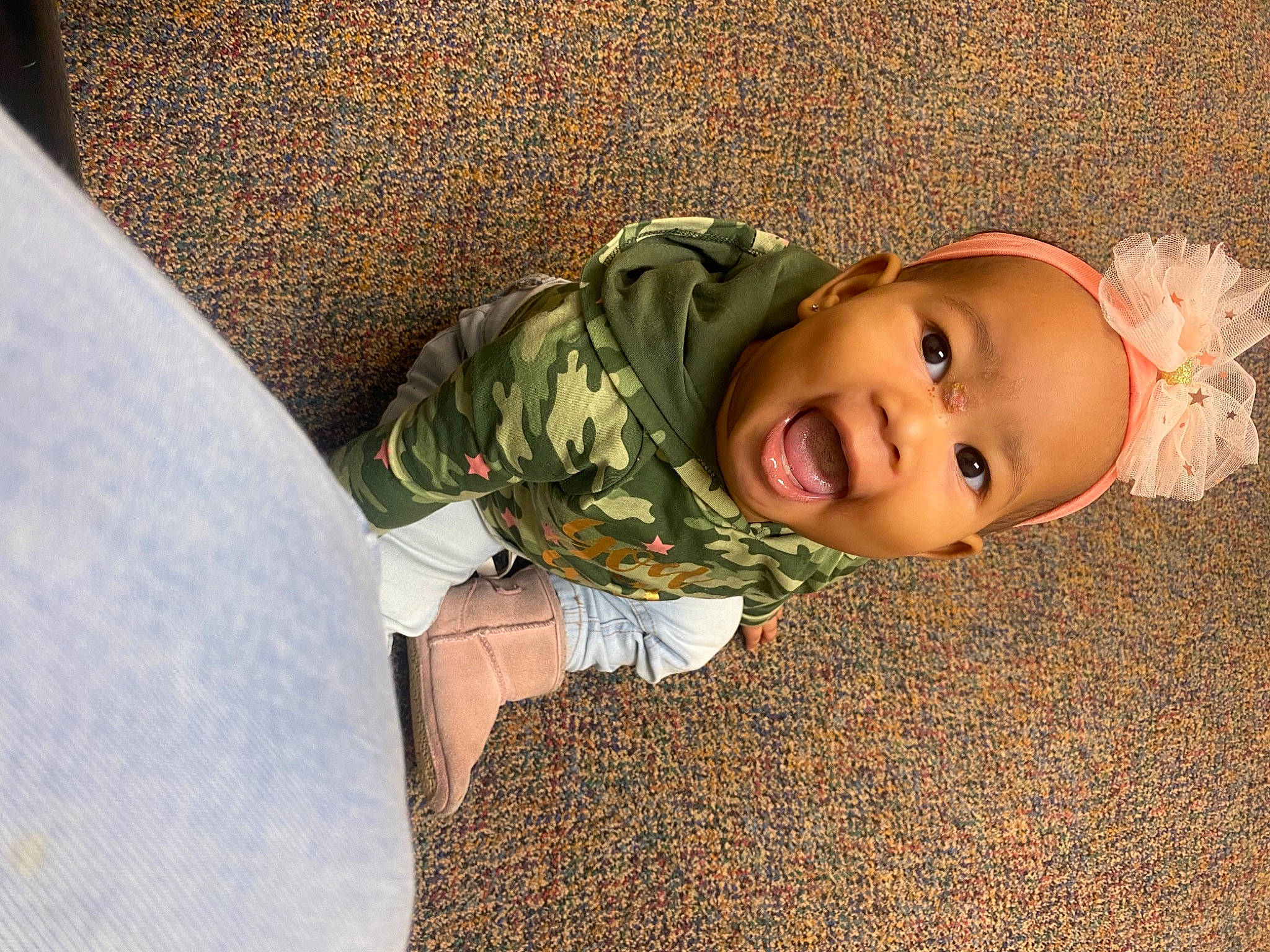 Amari'A is registered to the contest to win money with this photo: baby, baby_toddler_clothing, child, comfort, eye, flooring, fun, grass, happy, hat, human_body, linens, person, plant, sitting, skin, smile, tints_and_shades, toddler, tree