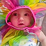 Emmett is registered to the contest to win money with this photo: baby, child, tutu, colorful, pink, rainbow, face, wide_eyes, blanket, patterned, cute, surprised, infant, clothing, fabric, portrait, indoors, person, soft, adorable