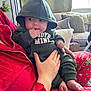 baby, hoodie, green_clothing, child, indoor, person, hand, fingers, face, couch, pajamas, feet, pillow, window, curtain, home, seated, cute, infant, cozy