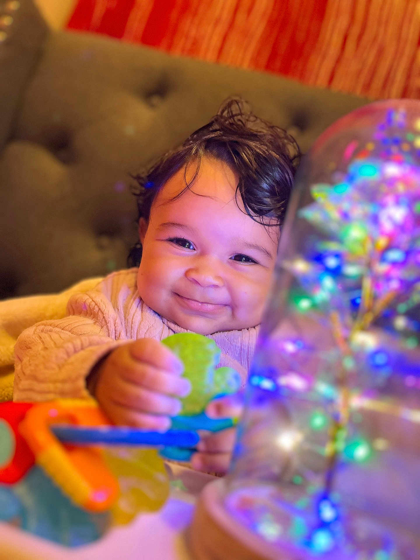 Esmeralda joined the competition — help win amazing prizes! baby, child, smile, toy, colorful, glowing, light, decorative, couch, cozy, indoor, happy, face, hand, clothing, warm, cute, portrait, infant, playtime