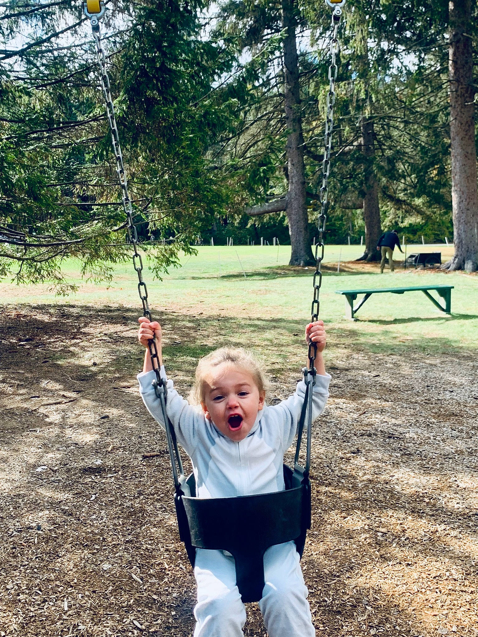 Azalea is registered to the contest to win money with this photo: balance, fun, grass, happy, leisure, natural_environment, outdoor_play_equipment, people_in_nature, person, plant, playground, playing_sports, recreation, smile, soil, summer, surprise, swing, t_shirt, toddler