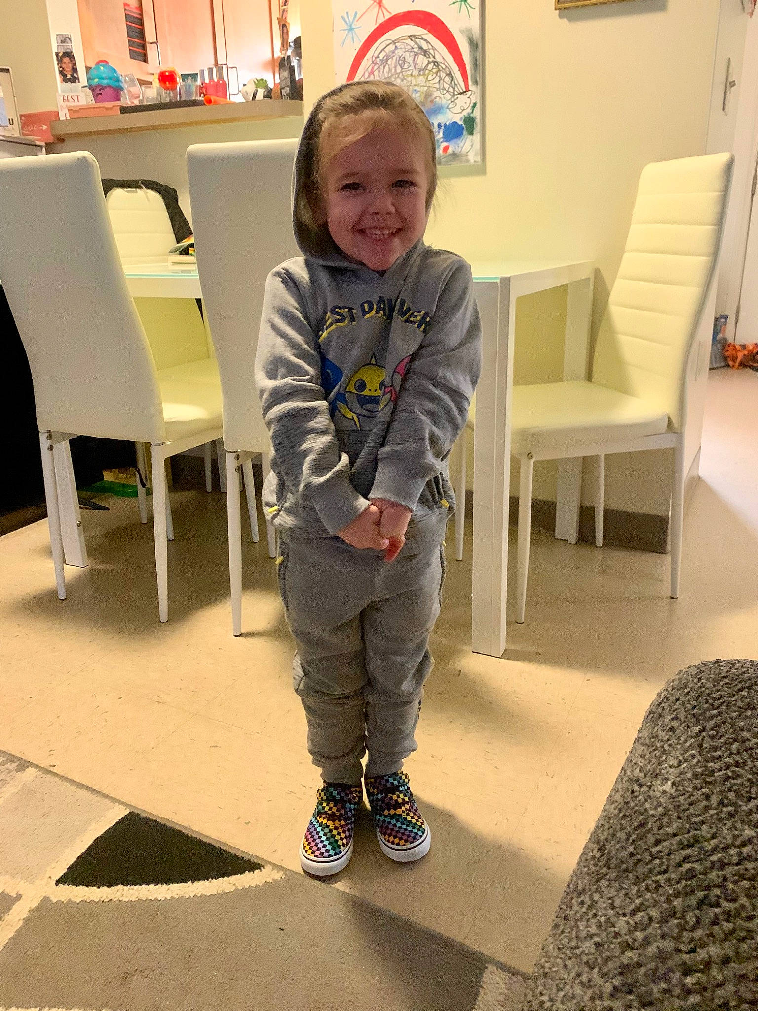 Azalea is registered to the contest to win money with this photo: chair, child, floor, flooring, furniture, hardwood, joint, joy, knee, person, picture_frame, play, room, shoe, sitting, sleeve, smile, sneakers, t_shirt, thigh