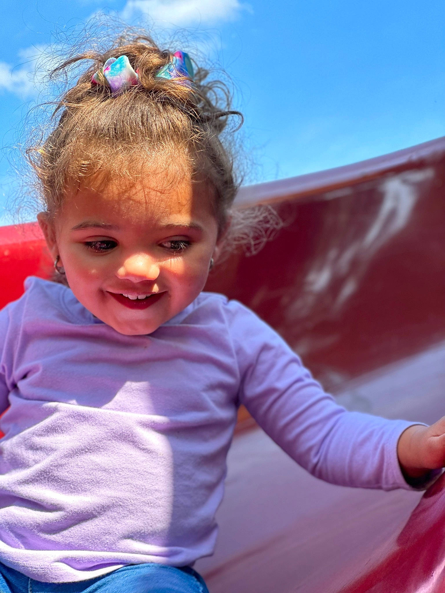 Melyona is registered to the contest to win money with this photo: child, cloud, electric_blue, eyewear, fun, grass, happy, joy, leisure, magenta, people_in_nature, person, personal_protective_equipment, pink, recreation, sitting, sky, smile, sunglasses, t_shirt