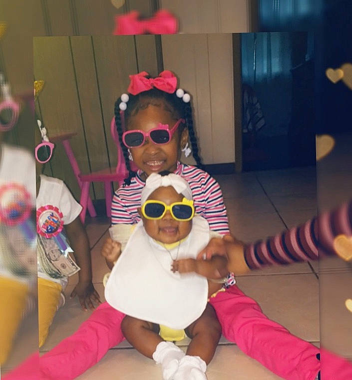 Akylah joined the competition — help win amazing prizes! arm, baby, child, costume, entertainment, event, eyewear, fun, goggles, happy, head, headwear, person, personal_protective_equipment, sitting, stuffed_toy, sunglasses, thigh, toddler, toy