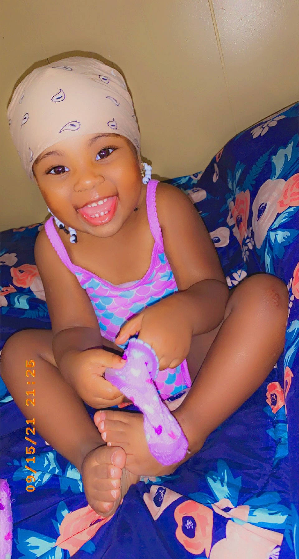 Akylah is registered to the contest to win money with this photo: baby_toddler_clothing, blue, eye, finger, fun, hand, happy, head, headwear, human_body, joy, leg, lip, magenta, mouth, nail, person, pink, purple, skin