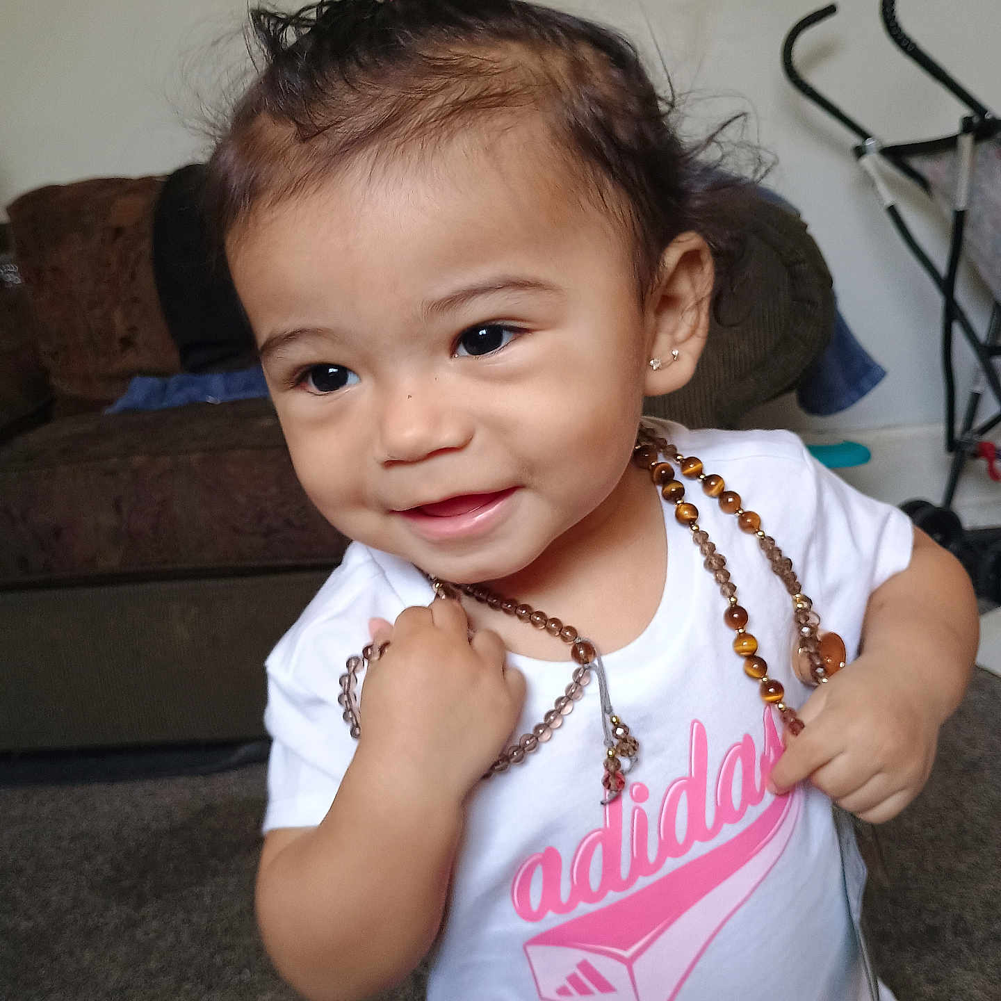 Le'Yani is registered to the contest to win money with this photo: accessories, bead, bodypart, child, clothing, couch, face, female, finger, furniture, girl, hand, head, jewelry, necklace, person, photography, portrait, prayer, t_shirt