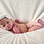 Delilah is registered to the contest to win money with this photo: newborn, baby, infant, headband, bow, blanket, soft, skin, cute, lying_down, portrait, indoors, closeup, human, small, peaceful, cozy, pink_skin, resting, child