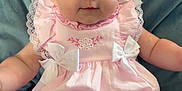 Delilah is registered to the contest to win money with this photo: adorable, baby, blue_background, bows, child, closeup, cushion, cute, happy, headband, indoors, infant, person, pink_dress, plush, portrait, sitting, smiling, soft_fabric, young_child
