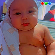 Tyler is registered to the contest to win money with this photo: arm, baby, background, belly, blurred_person, cheeks, child, colorful_emojis, cute, expression, face, hand, headscarf, heart_emoji, indoors, infant, person, portrait, skin, teddy_bear_pattern