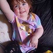 Abigail joined the competition — help win amazing prizes! toddler, child, smiling, waving, sitting, colorful_clothing, unicorn, leggings, blanket, couch, indoors, happy, face, hair, hand, cheerful, pattern, fabric, person, casual