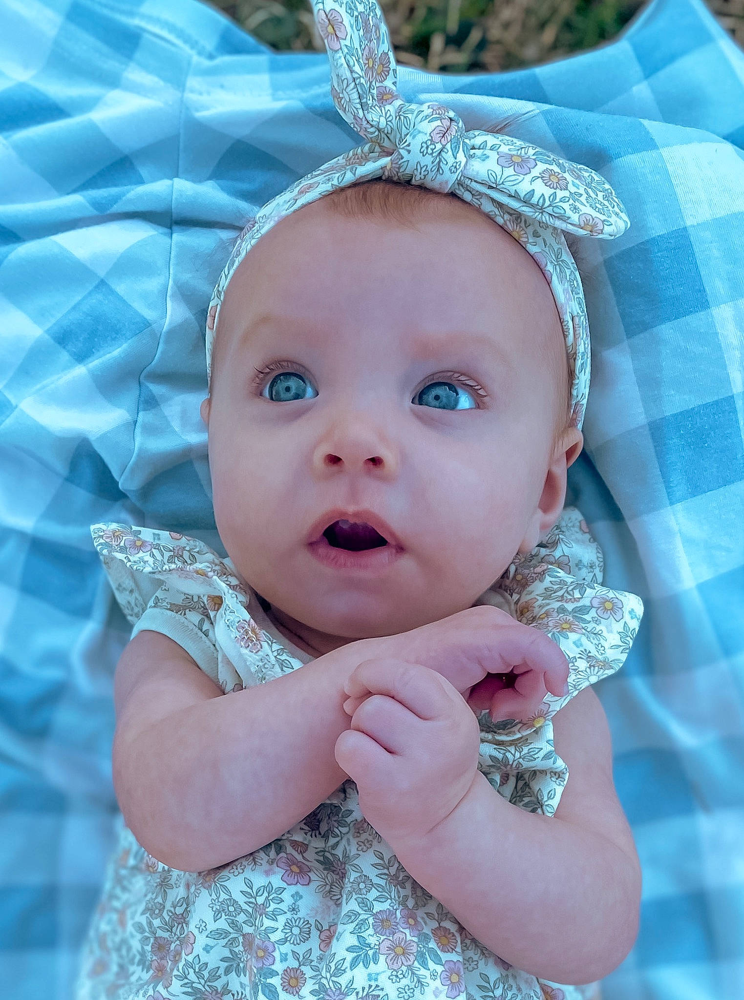 Andi is registered to the contest to win money with this photo: azure, baby, baby_toddler_clothing, child, costume_hat, eyelash, finger, gesture, grass, happy, headband, headgear, headpiece, iris, jewellery, lip, person, pink, purple, skin