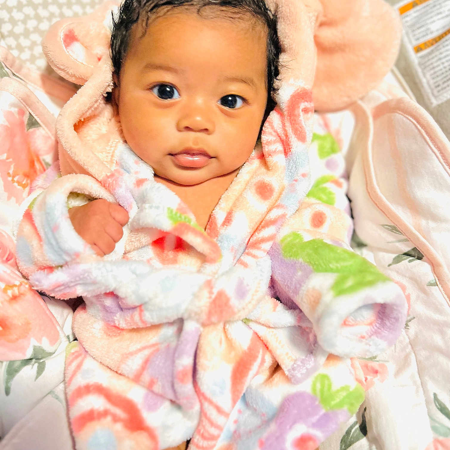 Keliana is registered to the contest to win money with this photo: baby, blanket, child, colorful, comfort, cute, ears, eyes, face, floral, fluffy, hand, hood, indoors, infant, person, portrait, robe, skin, soft