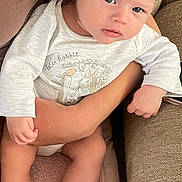 Rueben joined the competition — help win amazing prizes! baby, infant, person, child, onesie, peter_rabbit, blue_eyes, arm, couch, cushion, blanket, skin, hand, foot, clothing, indoor, relaxing, comfort, seated, portrait