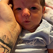 Gabriella is registered to the contest to win money with this photo: baby, babywear, care, child, closeup, clothing, cute, expression, face, hand, indoor, infant, love, newborn, onesie, parent, person, portrait, skin, tattoo