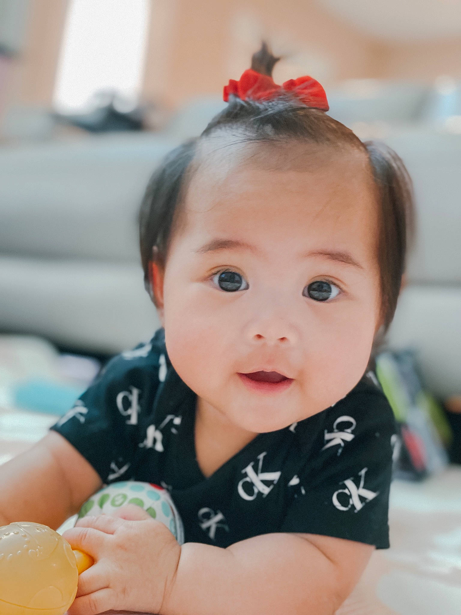 Alexandria is registered to the contest to win money with this photo: baby, baby_toddler_clothing, cheek, child, comfort_food, dress, fashion_accessory, hair, happy, headband, headpiece, orange_soft_drink, person, portrait_photography, room, sitting, skin, sleeve, sweetness, toddler