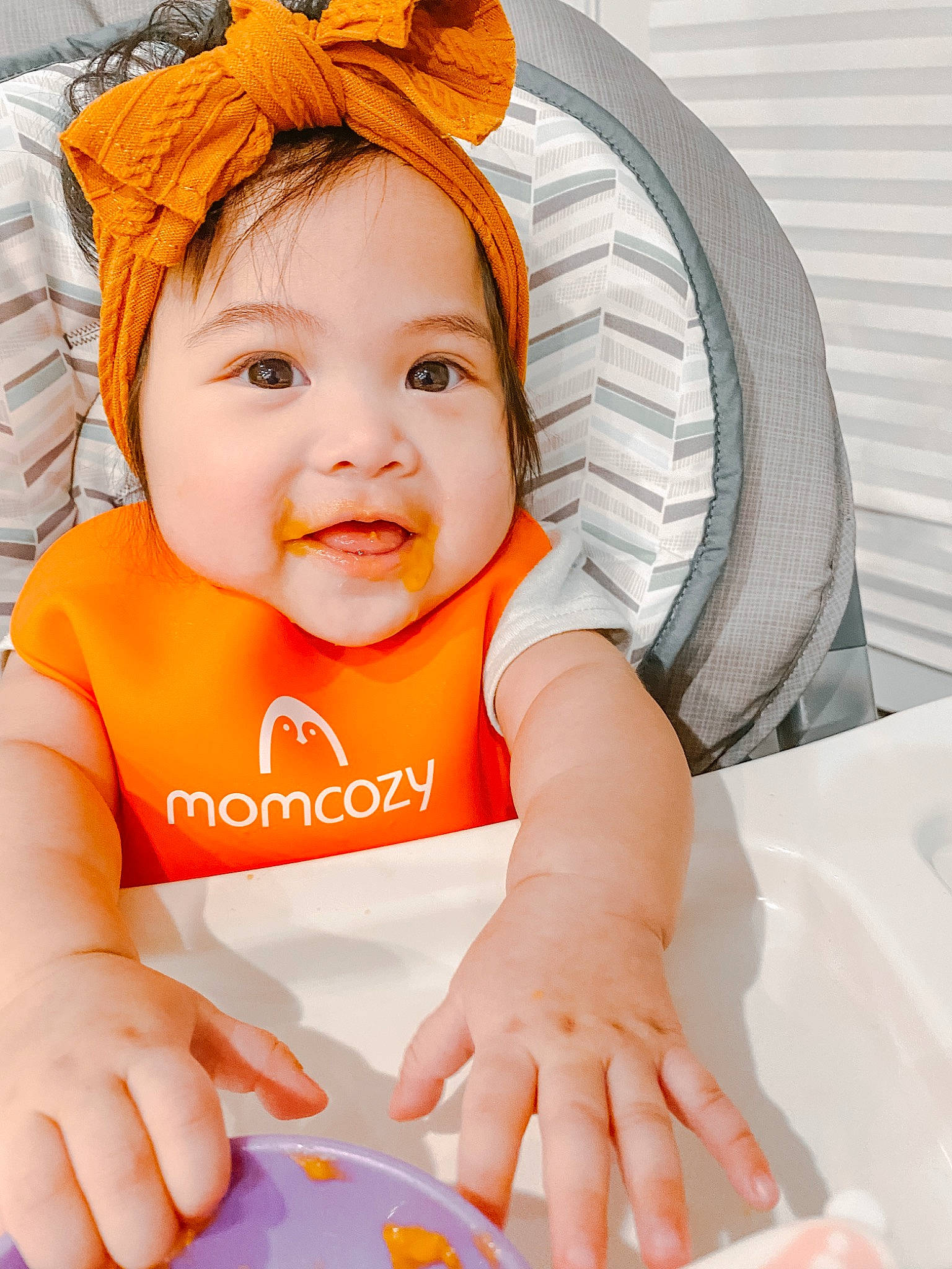 Alexandria is registered to the contest to win money with this photo: baby, baby_toddler_clothing, cheek, chin, comfort, eye, face, facial_expression, finger, happy, head, headwear, iris, orange, person, product, skin, sleeve, smile, textile